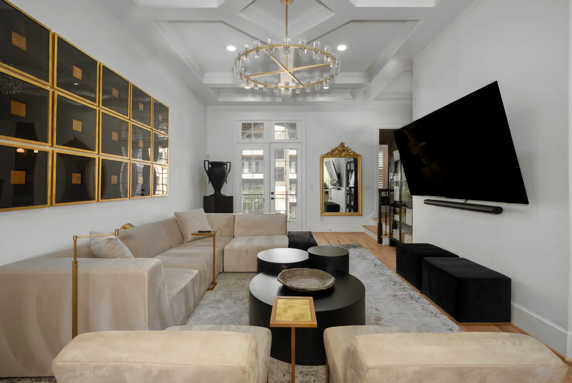 Living room with coffered ceiling and designer chandelier