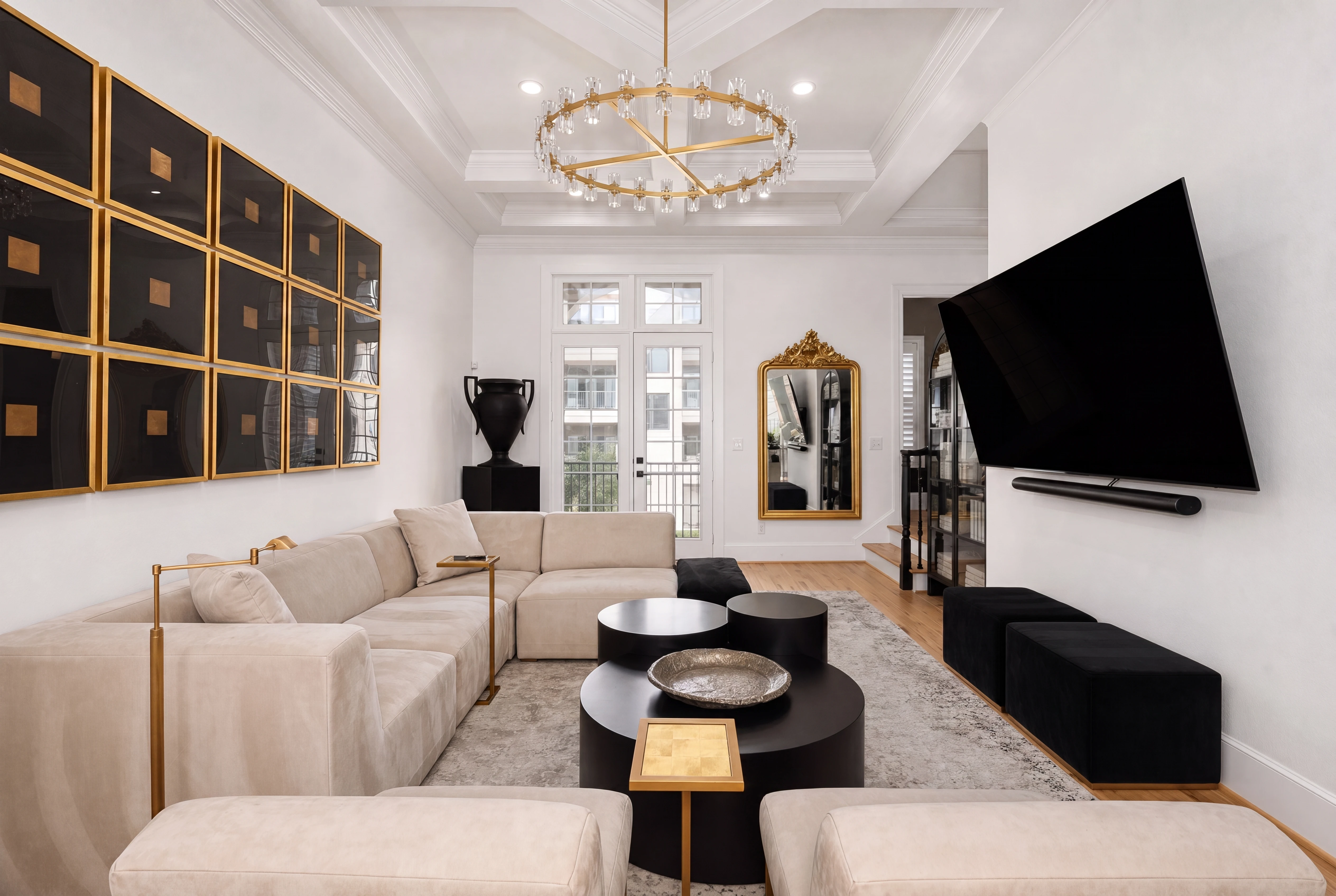 Living room with coffered ceiling and designer chandelier